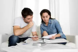 young couple stressing over bad financial situation